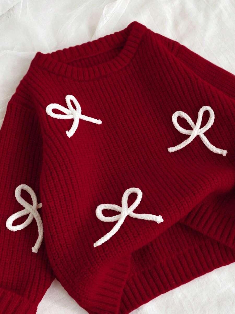 czerwony sweter kokarda