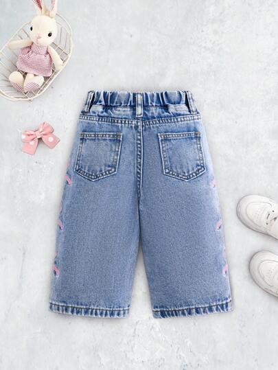 niebieskie spodnie jeans kokardy 