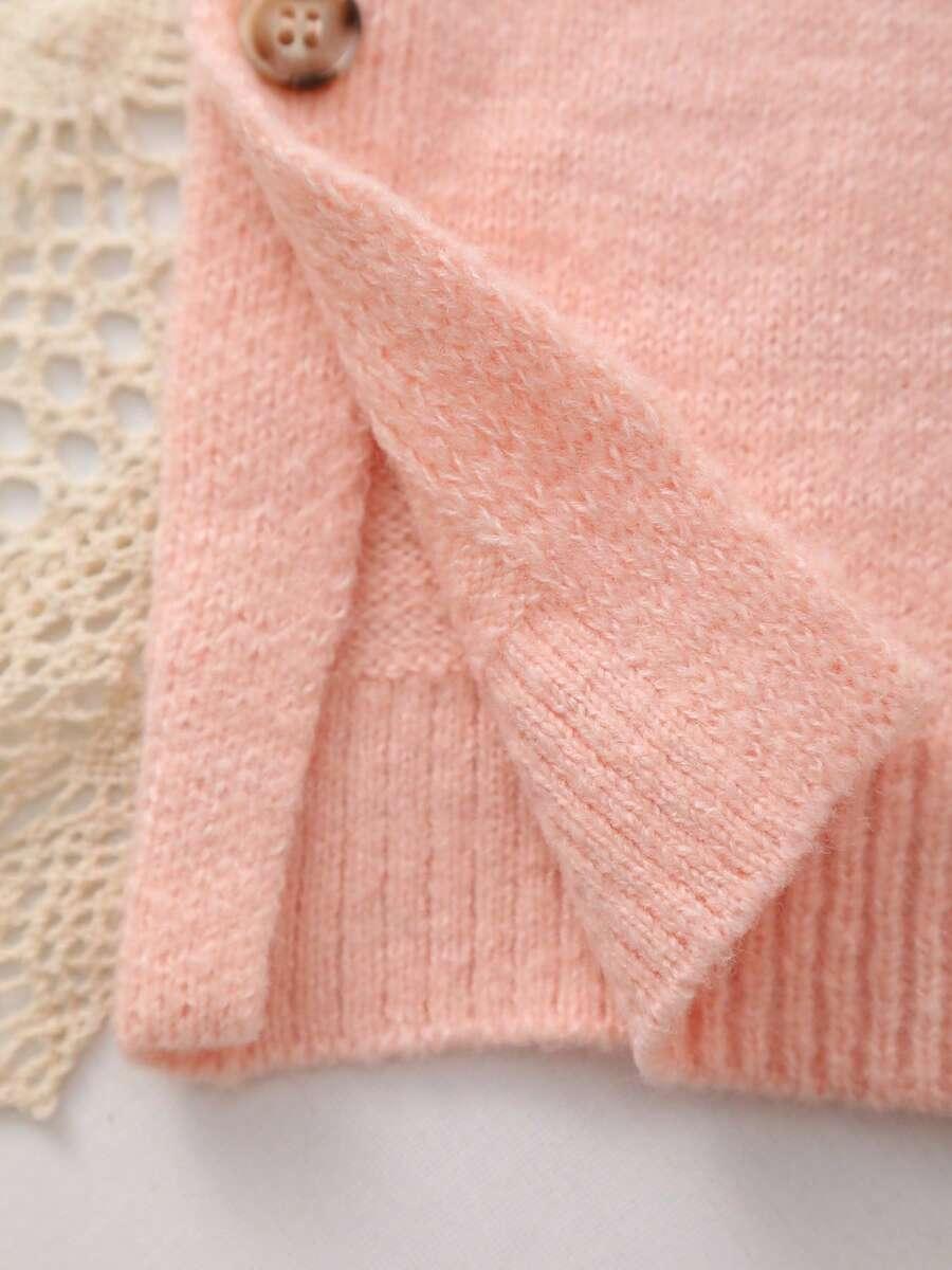 różowy sweter okrągły dekolt guziki