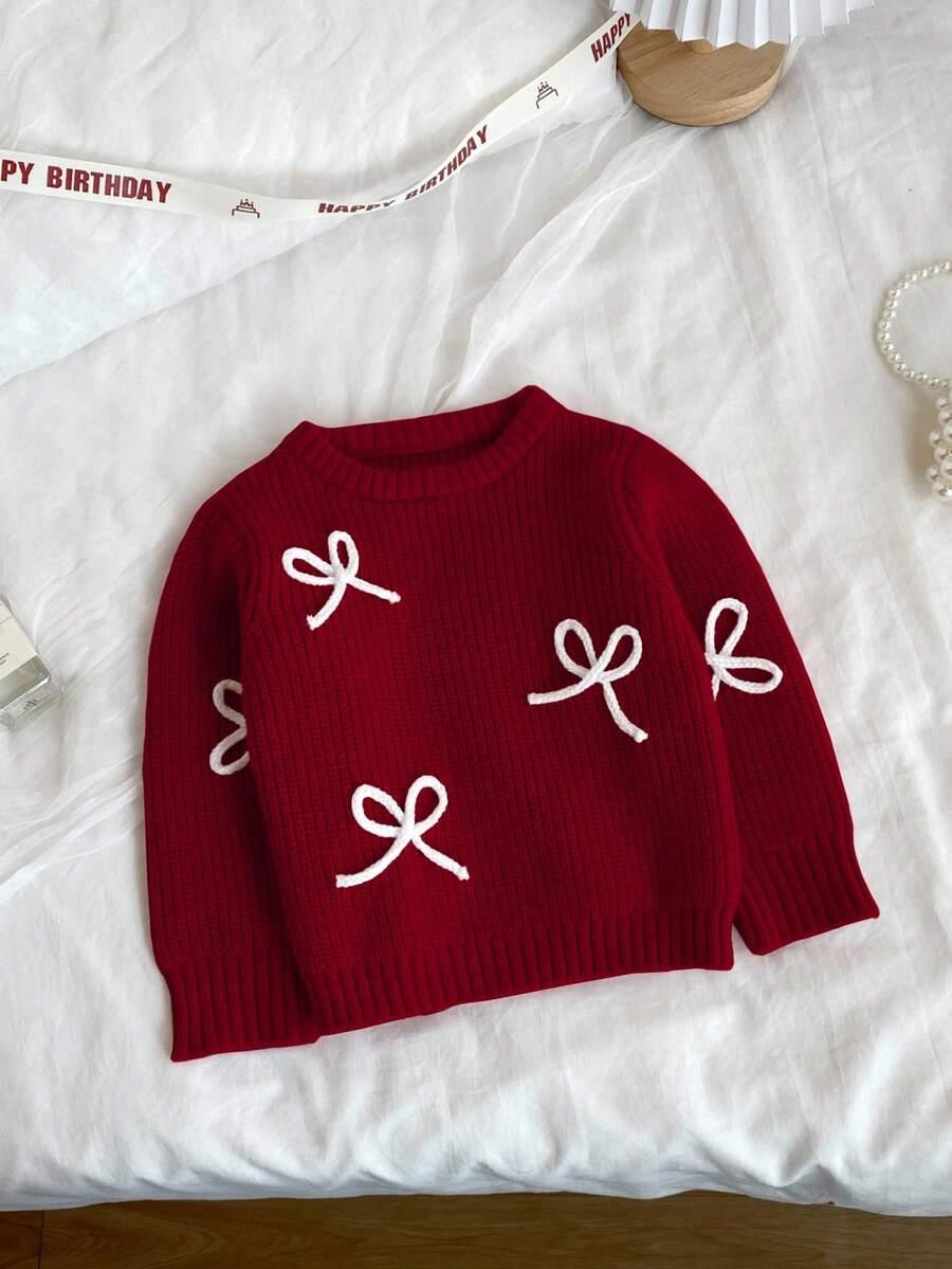 czerwony sweter kokarda