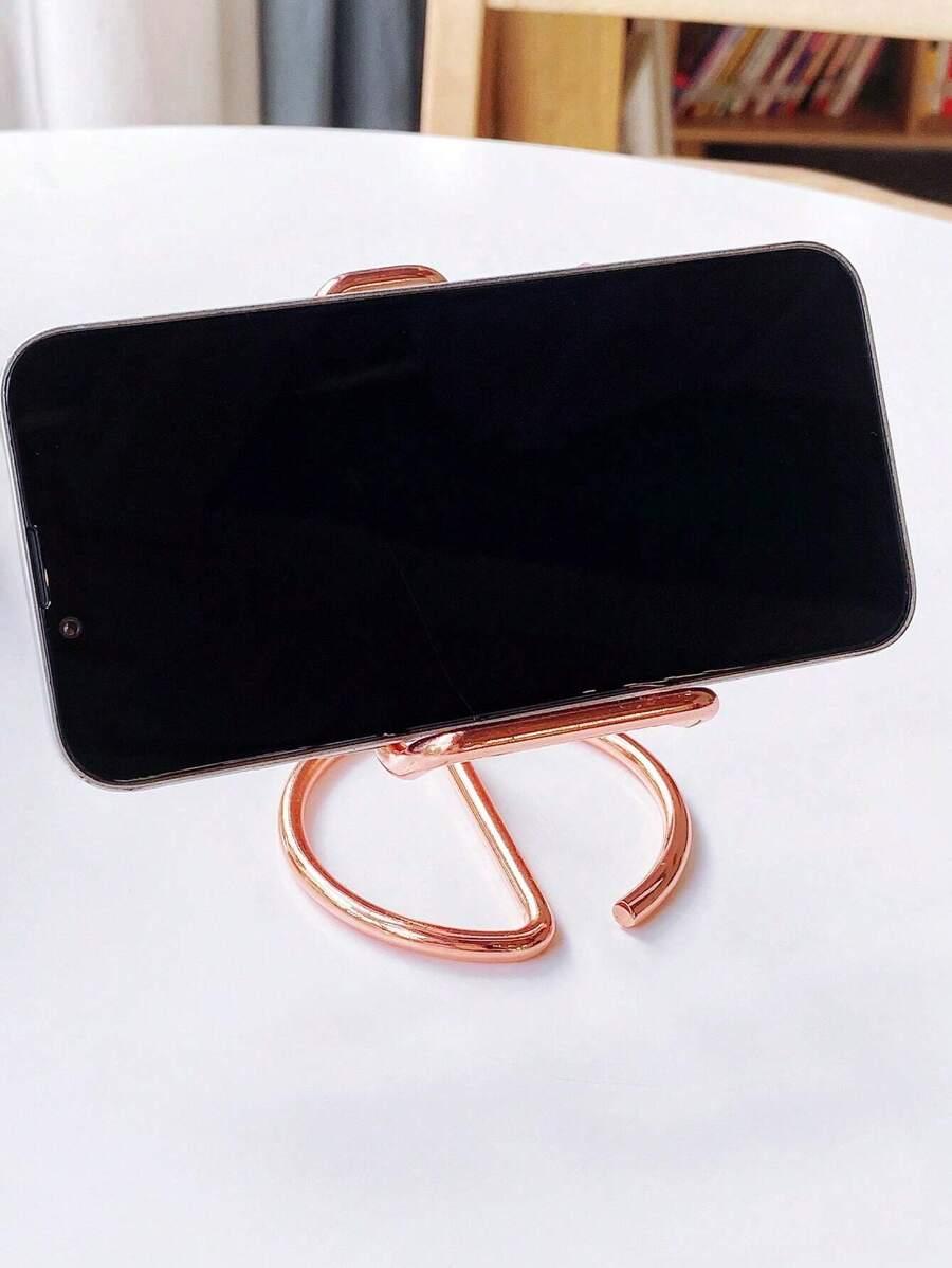 różowy metalowy stojak na telefom