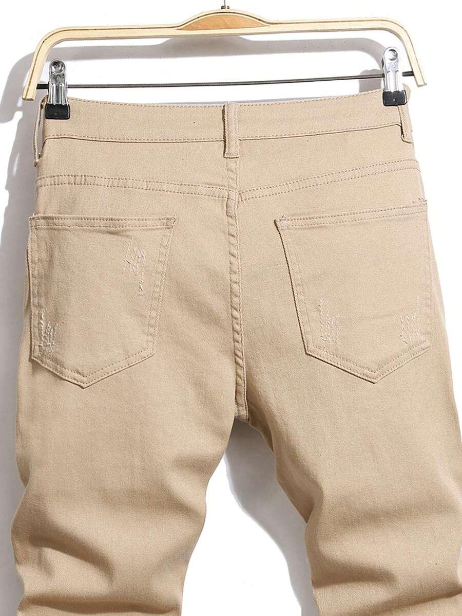 BEŻOWE SPODNIE JEANS PRZETARCIA