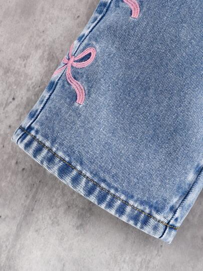 niebieskie spodnie jeans kokardy 