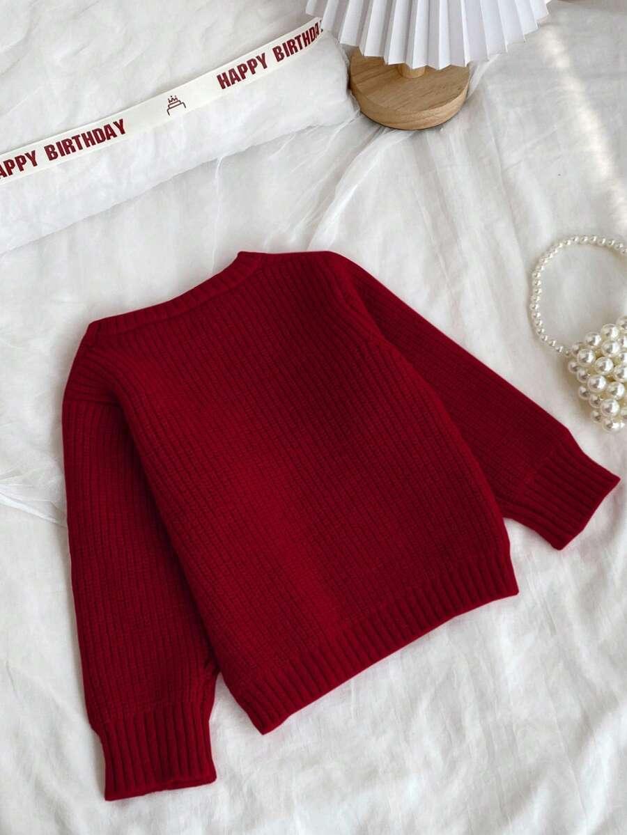 czerwony sweter kokarda