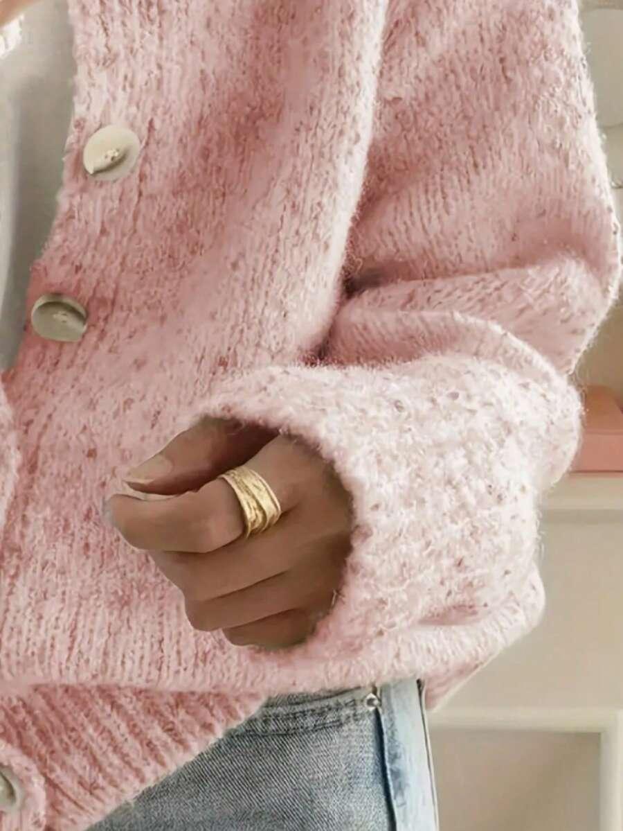 różowy sweter zapinany guziki