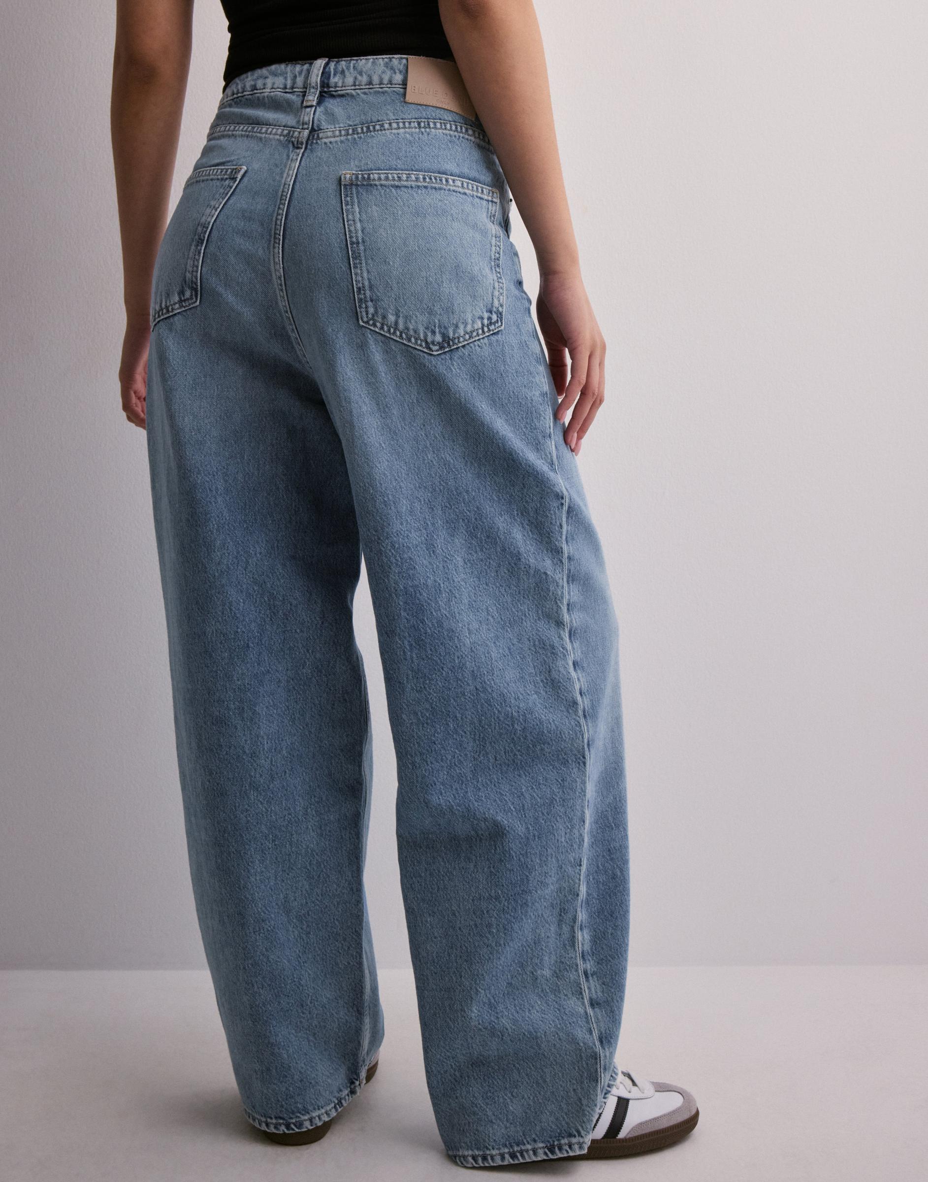 spodnie wide leg jeans kieszenie asymetria guziki