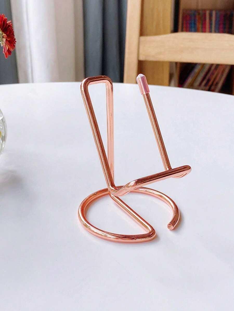 różowy metalowy stojak na telefom