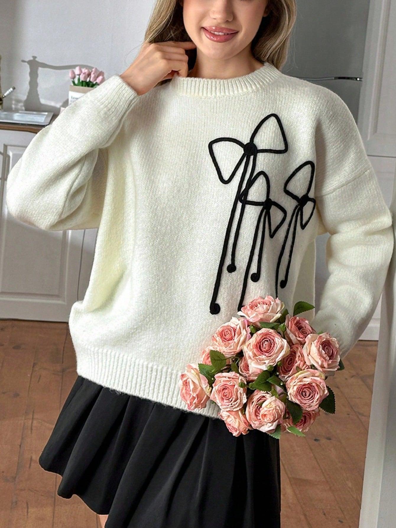 sweter z kokardkami