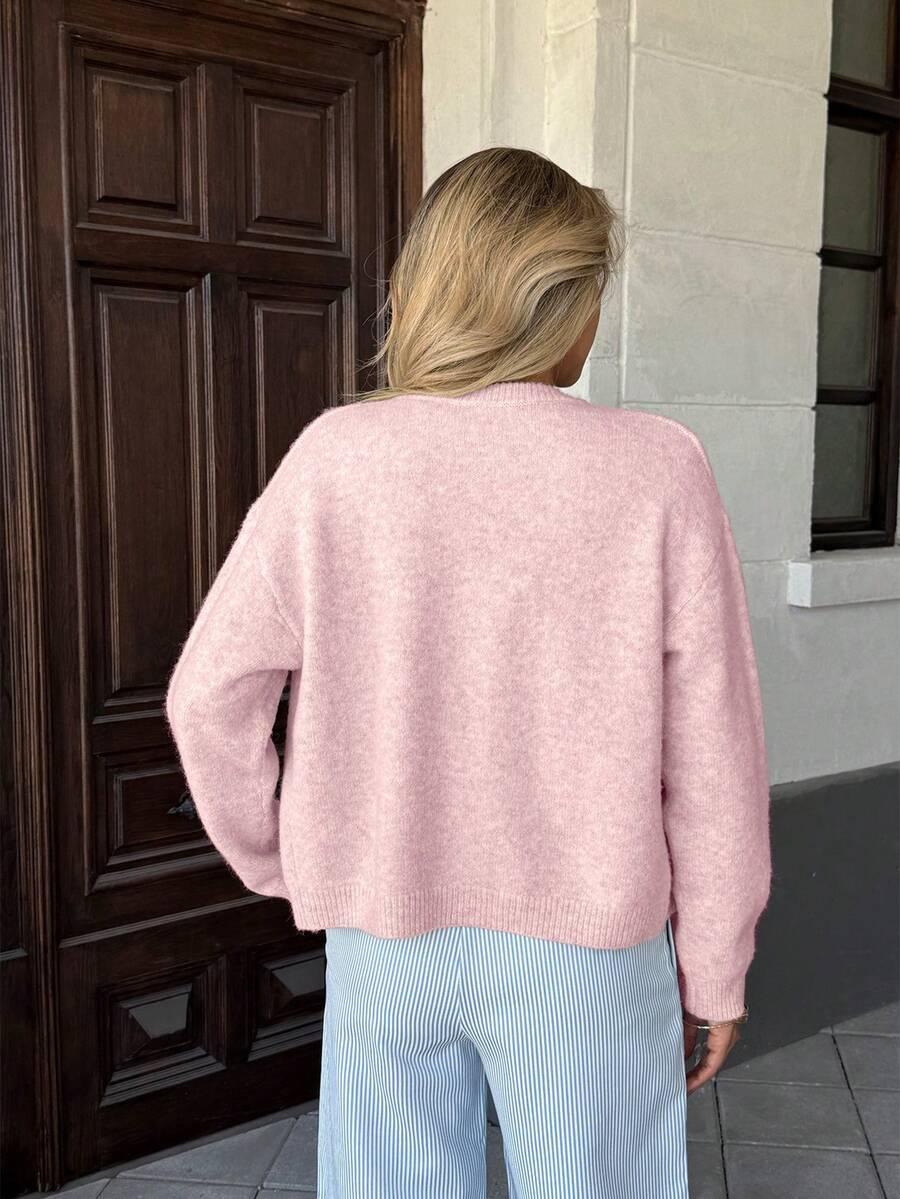 różowy sweter guziki