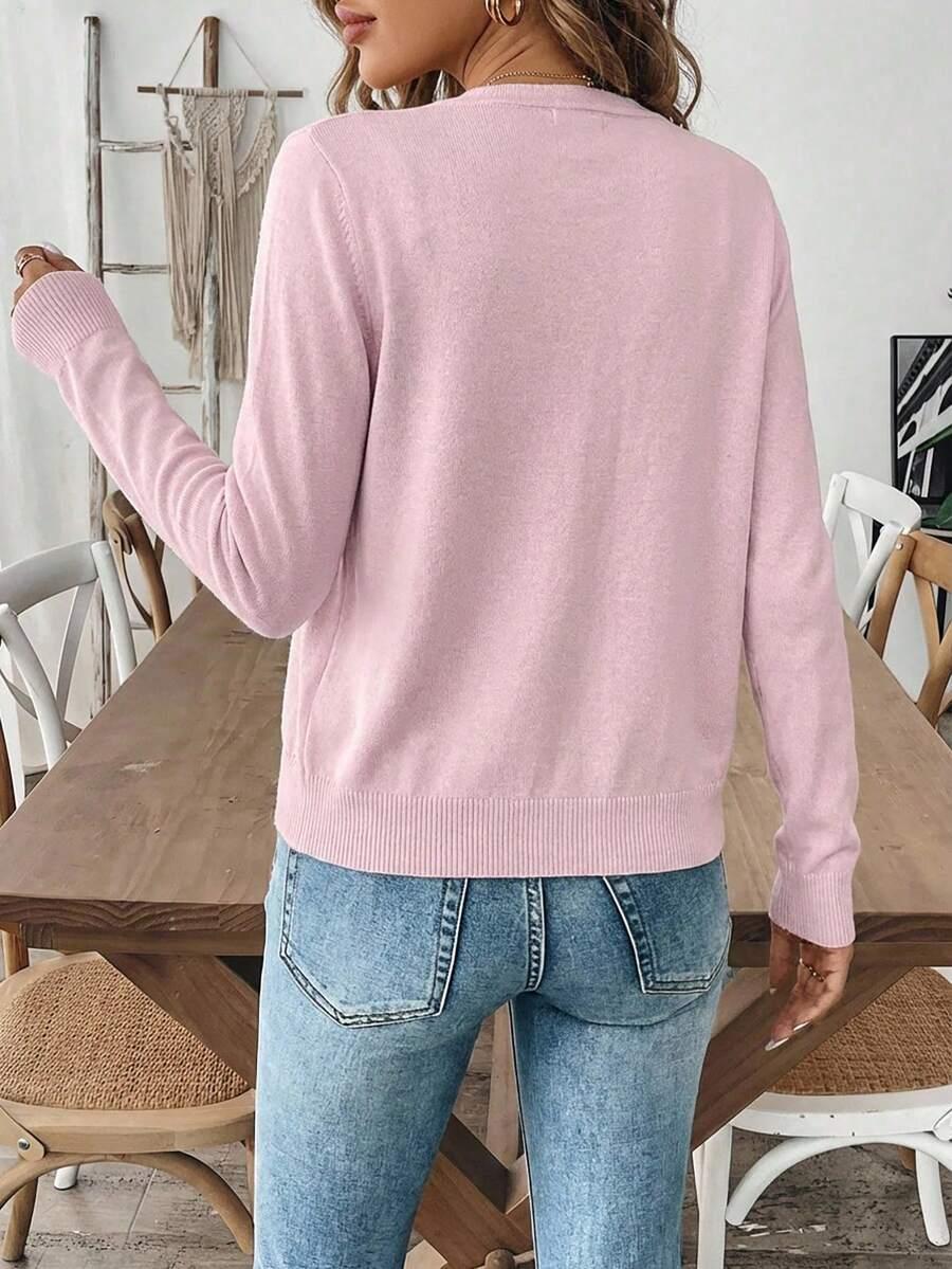 różowy sweter zapinany guziki