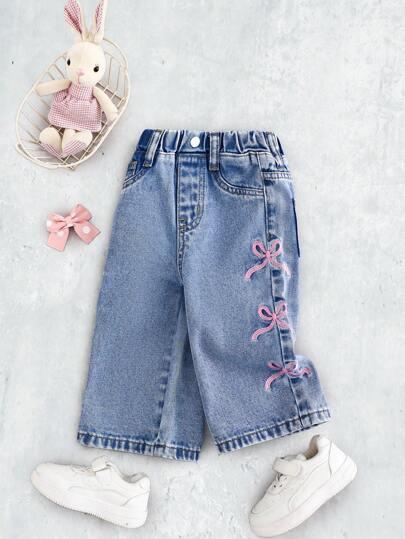 niebieskie spodnie jeans kokardy 