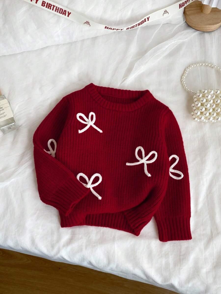 czerwony sweter kokarda