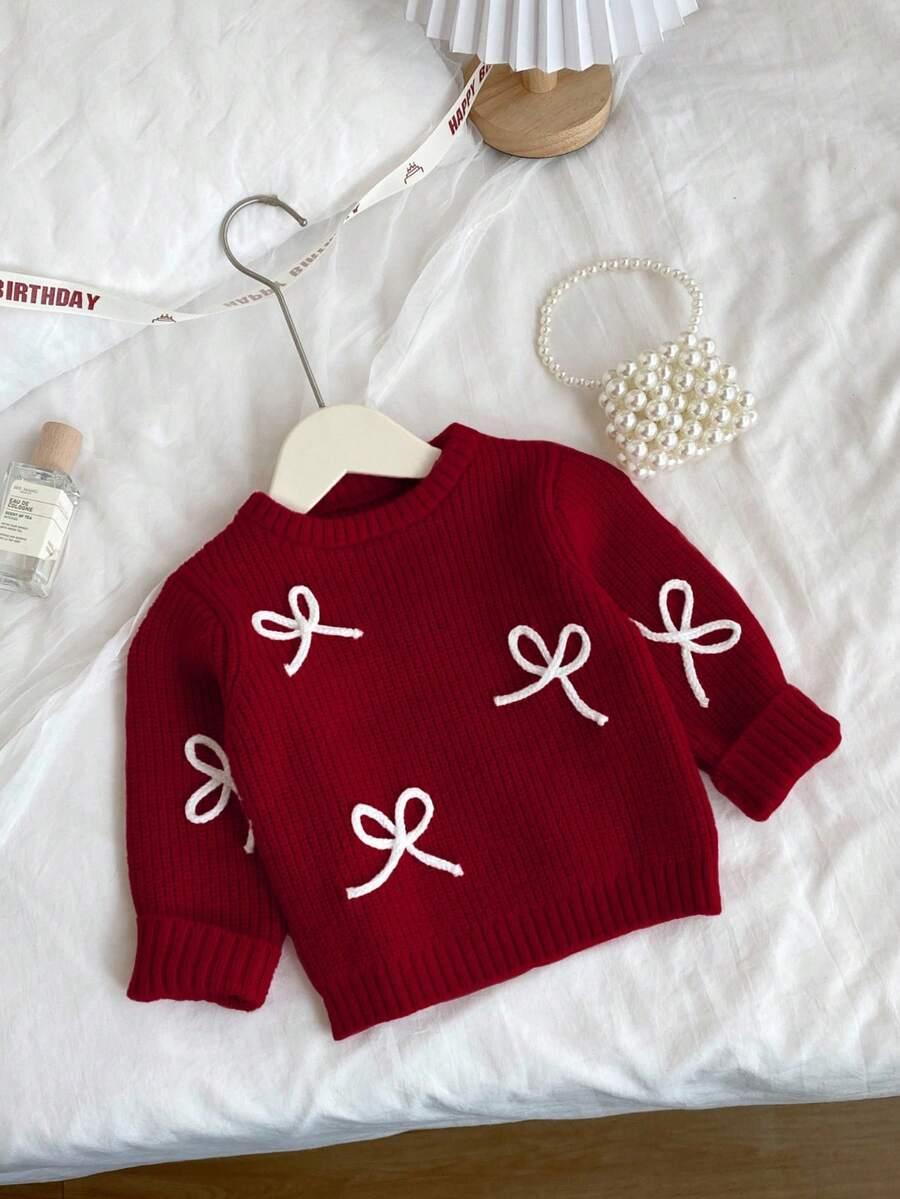 czerwony sweter kokarda