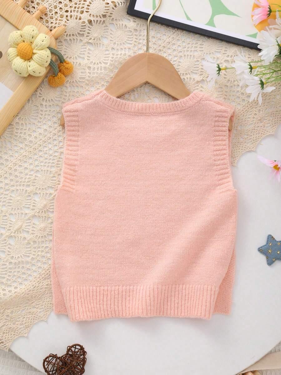 różowy sweter okrągły dekolt guziki